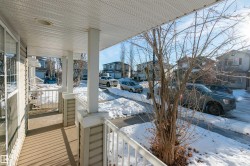 Snow covered back of property with a residential view and covered porch - 