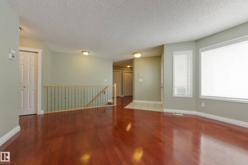 Unfurnished room with wood finished floors and a textured ceiling - 9916 178 Avenue, Edmonton, AB - Indoor Photo Showing Other Room