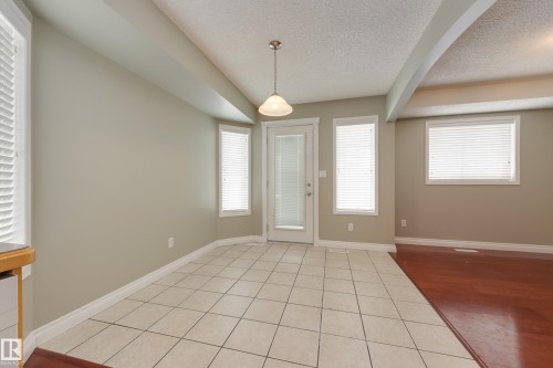 Entryway with light tile patterned floors and a textured ceiling - 9916 178 Avenue, Edmonton, AB - Indoor Photo Showing Other Room