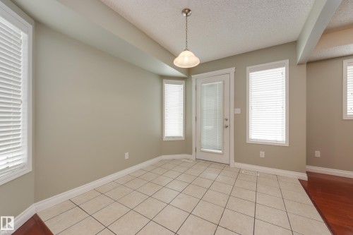 Unfurnished room featuring a textured ceiling and light tile patterned floors - 9916 178 Avenue, Edmonton, AB - Indoor Photo Showing Other Room