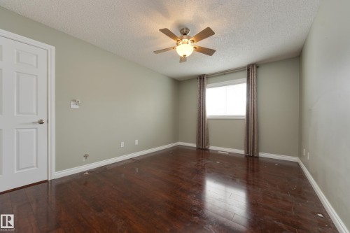 Unfurnished room with dark wood finished floors, a textured ceiling, and a ceiling fan - 9916 178 Avenue, Edmonton, AB - Indoor Photo Showing Other Room