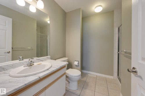 Full bathroom featuring vanity, a shower stall, and light tile patterned floors - 9916 178 Avenue, Edmonton, AB - Indoor Photo Showing Bathroom
