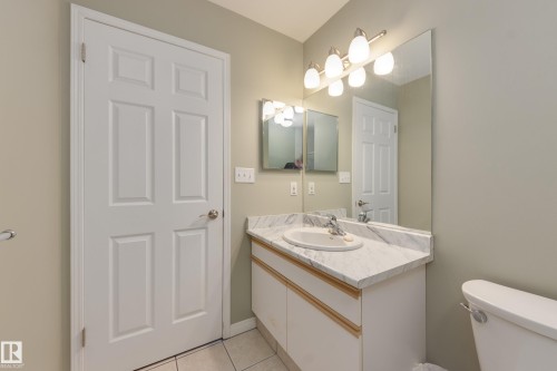 Half bathroom featuring vanity and light tile patterned flooring - 9916 178 Avenue, Edmonton, AB - Indoor Photo Showing Bathroom