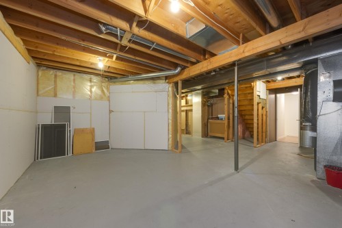 Unfinished below grade area featuring stairway and heating unit - 9916 178 Avenue, Edmonton, AB - Indoor Photo Showing Basement