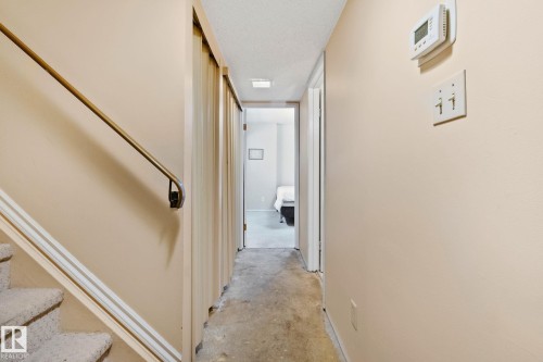Hallway with unfinished concrete floors and stairway - 313 Willow Court, Edmonton, AB - Indoor Photo Showing Other Room