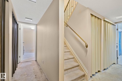 Staircase featuring concrete floors and a textured ceiling - 313 Willow Court, Edmonton, AB - Indoor Photo Showing Other Room