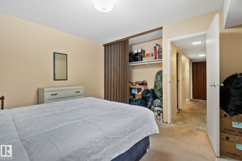 Bedroom featuring a textured ceiling, a closet, and light colored carpet - 313 Willow Court, Edmonton, AB - Indoor Photo Showing Bedroom