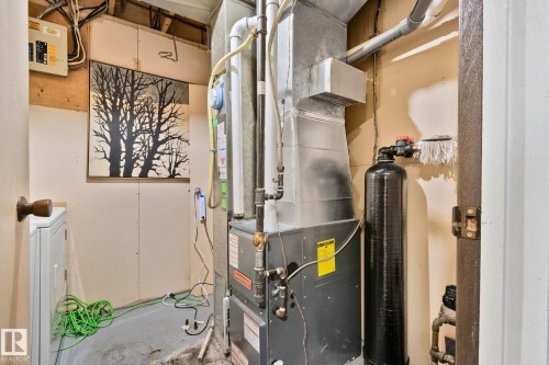Utility room featuring heating unit, washer / clothes dryer, and electric panel - 313 Willow Court, Edmonton, AB - Indoor Photo Showing Basement