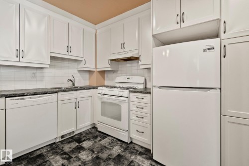 Kitchen featuring white appliances, white cabinets, and decorative backsplash - 313 Willow Court, Edmonton, AB - Indoor Photo Showing Kitchen