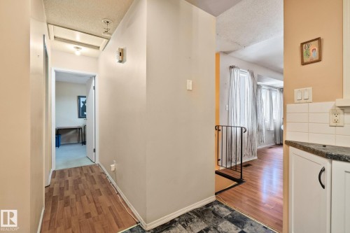 Hall with dark wood-type flooring and a textured ceiling - 313 Willow Court, Edmonton, AB - Indoor Photo Showing Other Room