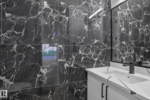 Bathroom with vanity and tile walls - 15415 20 Street, Edmonton, AB - Indoor Photo Showing Bathroom