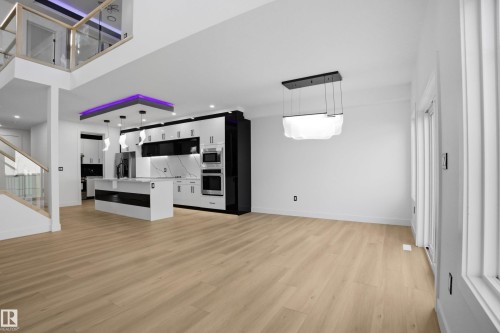 Unfurnished living room featuring light wood finished floors and recessed lighting - 15415 20 Street, Edmonton, AB - Indoor Photo Showing Other Room