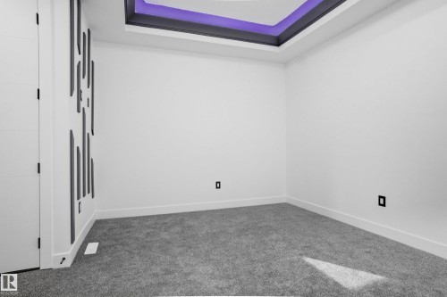 Unfurnished room featuring carpet floors and a tray ceiling - 15415 20 Street, Edmonton, AB - Indoor Photo Showing Other Room