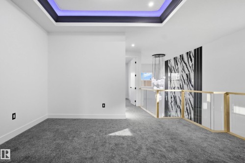 Carpeted empty room with a tray ceiling - 15415 20 Street, Edmonton, AB - Indoor Photo Showing Other Room
