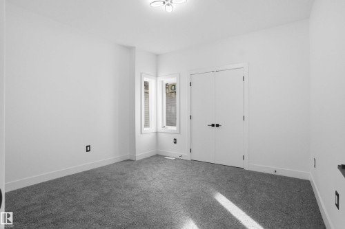 Carpeted spare room featuring baseboards - 15415 20 Street, Edmonton, AB - Indoor Photo Showing Other Room