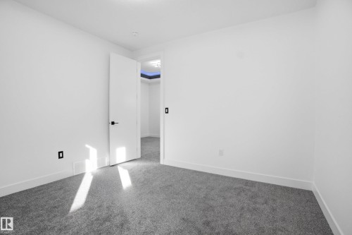 Carpeted spare room with baseboards - 15415 20 Street, Edmonton, AB - Indoor Photo Showing Other Room