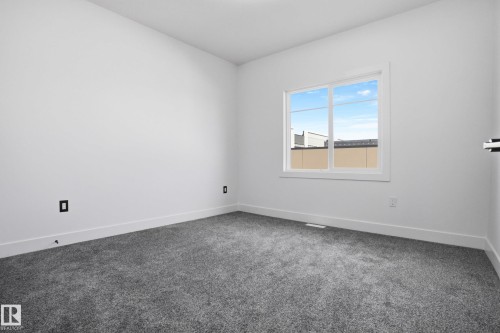 Carpeted spare room with baseboards - 15415 20 Street, Edmonton, AB - Indoor Photo Showing Other Room