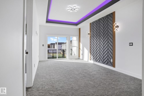 Empty room featuring a raised ceiling and carpet - 15415 20 Street, Edmonton, AB - Indoor Photo Showing Other Room
