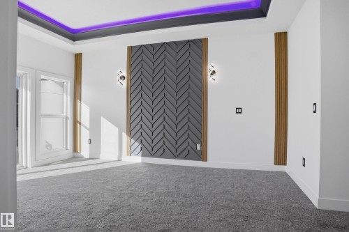 Spare room featuring carpet flooring, wallpapered walls, and a tray ceiling - 15415 20 Street, Edmonton, AB - Indoor Photo Showing Other Room
