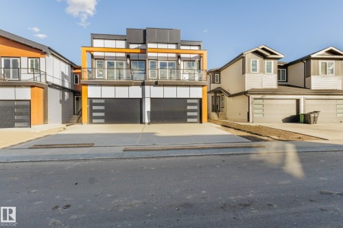Contemporary home with a garage, concrete driveway, and a balcony - 15415 20 Street, Edmonton, AB - Outdoor With Balcony
