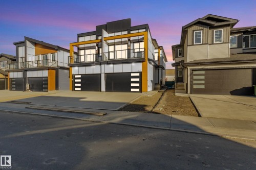 Contemporary home with a garage, concrete driveway, and board and batten siding - 15415 20 Street, Edmonton, AB - Outdoor With Balcony