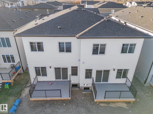 Back of property with roof with shingles, a deck, and a residential view - 15415 20 Street, Edmonton, AB - Outdoor