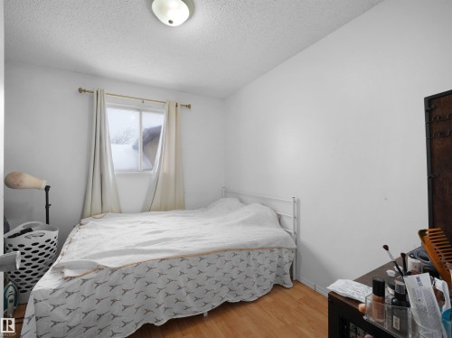 Bedroom with light wood-style flooring and a textured ceiling - 17122 96 Street, Edmonton, AB - Indoor Photo Showing Bedroom