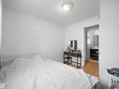 Bedroom with wood finished floors and a textured ceiling - 17122 96 Street, Edmonton, AB - Indoor Photo Showing Bedroom
