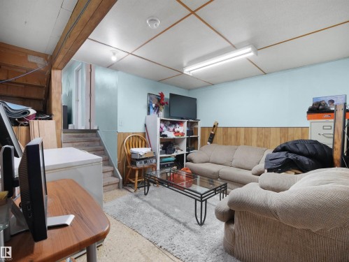 Living area with wood walls and wainscoting - 17122 96 Street, Edmonton, AB - Indoor