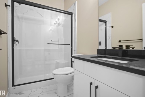 Full bathroom with vanity, a marble finish shower, and light marble finish flooring - 3910 41 Avenue, Beaumont, AB - Indoor Photo Showing Bathroom