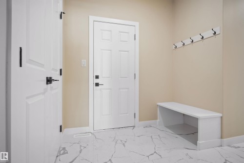 Mudroom featuring baseboards and light marble finish flooring - 3910 41 Avenue, Beaumont, AB - Indoor Photo Showing Other Room