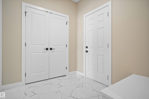 Foyer entrance featuring light marble finish floors and baseboards - 3910 41 Avenue, Beaumont, AB - Indoor Photo Showing Other Room