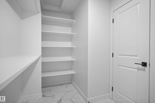 Walk in closet with attic access and light marble finish flooring - 3910 41 Avenue, Beaumont, AB - Indoor