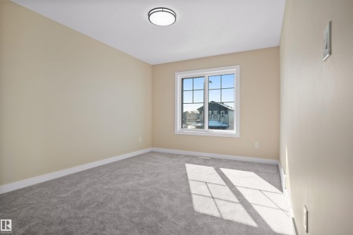 Empty room with light colored carpet and baseboards - 3910 41 Avenue, Beaumont, AB - Indoor Photo Showing Other Room