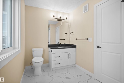 Bathroom with light marble finish flooring and vanity - 3910 41 Avenue, Beaumont, AB - Indoor Photo Showing Bathroom