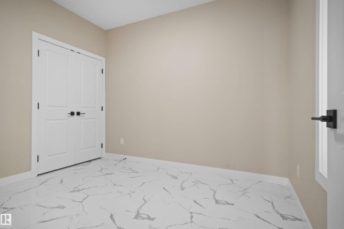 Unfurnished bedroom with a closet and light marble finish floors - 3910 41 Avenue, Beaumont, AB - Indoor Photo Showing Other Room