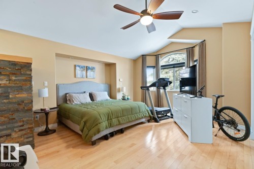 Bedroom Featuring Hardwood Flooring, Ceiling Fan, Pot Lights, Mirrored Door To Walk-In Closet With Built-In Shelving. - 10216 89 Street, Edmonton, AB - Indoor Photo Showing Bedroom