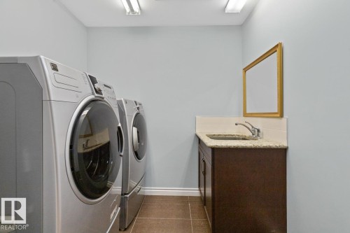 Laundry Room With Washer & Dryer Plus Cupboard With Convenient Sink. - 10216 89 Street, Edmonton, AB - Indoor Photo Showing Laundry Room
