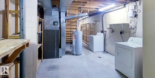 Unfinished basement with heating unit and water heater - 1102 55 Street, Edson, AB - Indoor Photo Showing Laundry Room