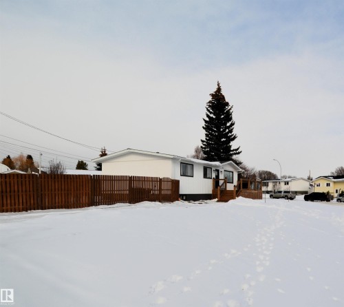 View of property exterior featuring a deck - 1102 55 Street, Edson, AB - Outdoor