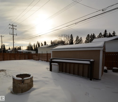 Yard covered in snow featuring a fenced backyard - 1102 55 Street, Edson, AB - Outdoor