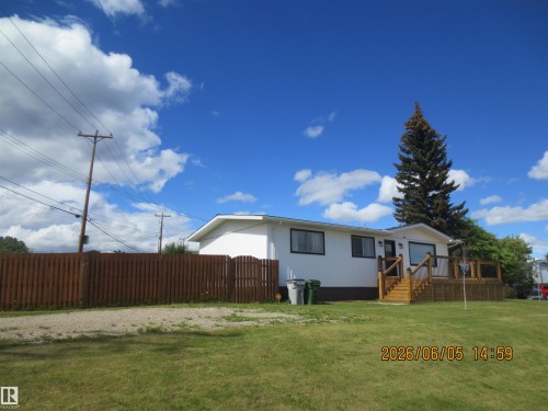 Ranch-style residence featuring white siding and black trim windows - 1102 55 Street, Edson, AB 