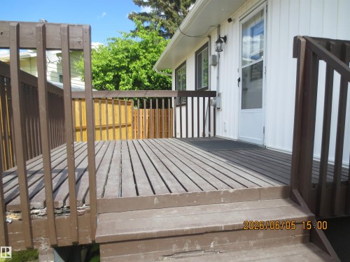 Expansive wood deck with railing and exterior access - 1102 55 Street, Edson, AB 