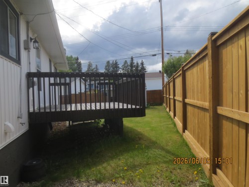 Elevated dark wood deck with railing - 1102 55 Street, Edson, AB 