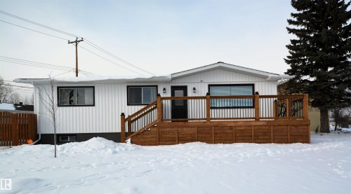 View of front facade with a wooden deck - 1102 55 Street, Edson, AB 