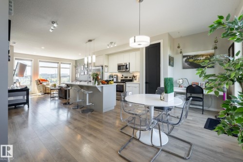 Dining room featuring dark wood finished floors and baseboards - 1710 Keene Crescent. Sw, Edmonton, AB - Indoor Photo Showing Dining Room