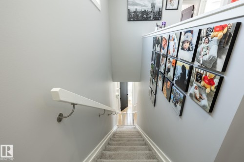 Staircase featuring carpet flooring and baseboards - 1710 Keene Crescent. Sw, Edmonton, AB - Indoor Photo Showing Other Room