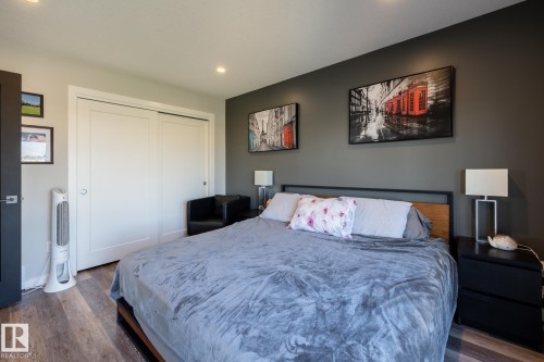 Bedroom with dark wood-style floors, recessed lighting, and a closet - 1710 Keene Crescent. Sw, Edmonton, AB - Indoor Photo Showing Bedroom