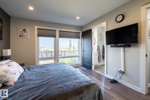 Bedroom with dark wood-style floors, ensuite bathroom, and recessed lighting - 1710 Keene Crescent. Sw, Edmonton, AB - Indoor Photo Showing Bedroom