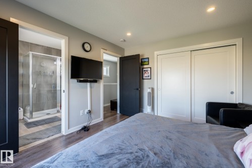 Bedroom with dark wood-style floors, recessed lighting, and a closet - 1710 Keene Crescent. Sw, Edmonton, AB - Indoor Photo Showing Bedroom